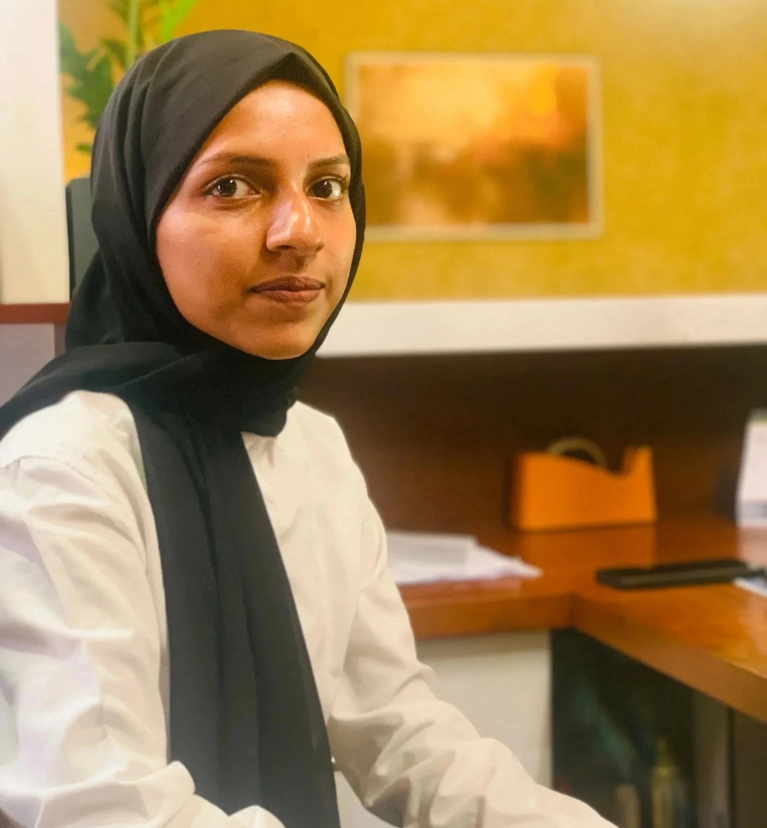 best digital marketer in Malappuram working professionally at office desk, confident woman in hijab with modern workspace background