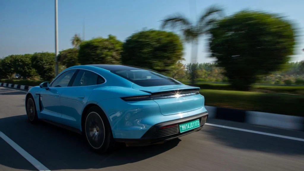 Porsche car price for Taycan electric car in India showing blue Porsche Taycan driving on road with modern design and EV performance